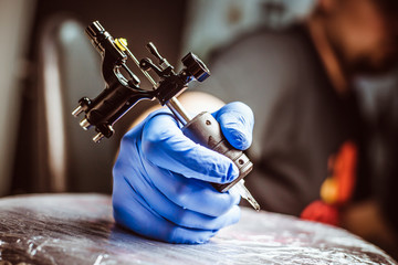 Tattooist makes a tattoo. Closeup