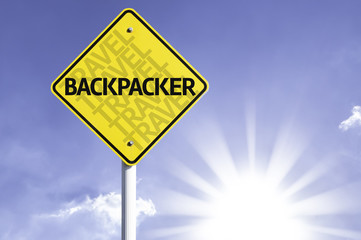 Wall Mural - Backpacker road sign with sun background