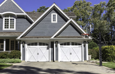 Traditional wooden car garage with driveway