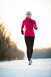 © lightpoet - Winter running - Young woman running outdoors on a cold winter