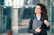 © pio3 - Happy business woman portrait outdoors with modern building as b
