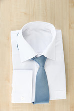New White Man's Shirt With Color Tie On Wooden Background