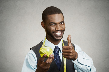 Happy smiling man advising on healthy diet, holding green apple