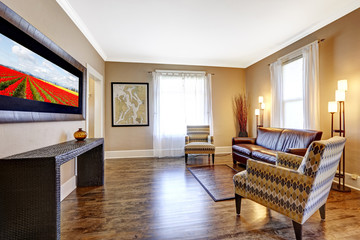 Living room interior with leather couch and two chairs