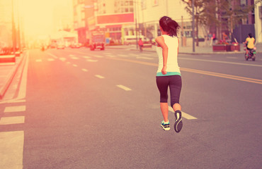 Poster -  Runner athlete running on city road.  