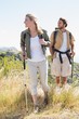 © WavebreakMediaMicro - Hiking couple walking on mountain trail