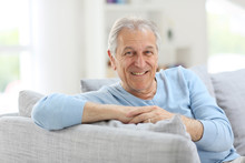 Portrait Of Smiling Senior Man With Blue Shirt