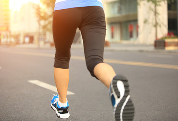 Wall Mural - Runner athlete running on city road.  