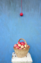 Wicker Wooden Basket With Red Apples On Seat