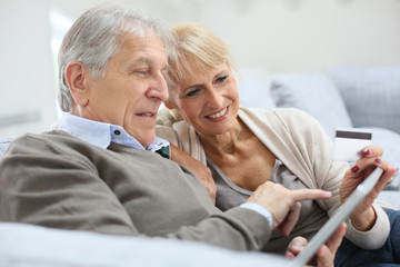 Poster - Senior couple e-shopping with digital tablet