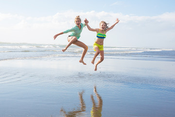 Canvas Print - two kids jumping at the beach