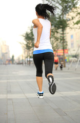 Wall Mural - Runner athlete running on city road.  