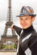 Young man hipster shows the Eiffel tower, Paris, France