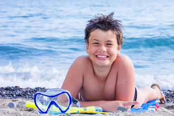 Happy young diver on the sea beach