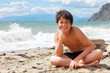Happy smiling boy on the sea beach