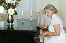 Elderly Woman Playing The Piano At Home