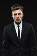 © mrcats - Handsome young man in suit on dark background