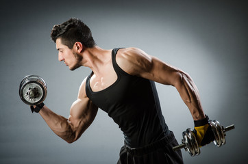 Muscular ripped bodybuilder with dumbbells