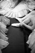 Ballerinas in puffy skirts sitting on the floor, monochrome