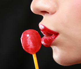 Young beautiful girl with lollipop in her mouth