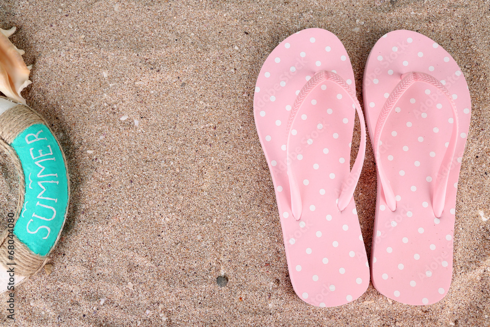 Color flip-flops on sand background