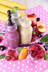 Canvas Print - Bottles of delicious smoothie on table, close-up