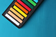© Africa Studio - Colorful chalk pastels in box on color wooden background
