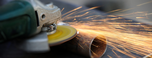 Wall Mural - Worker cutting metal with grinder