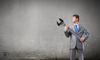 Businessman with wrench