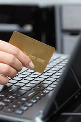 woman holding credit card on laptop for online shopping concep