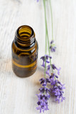 Fototapeta Lawenda - lavender essential oil on wooden surface