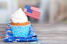 American Patriotic Holiday Cupcakes On Wooden Table