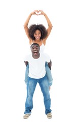 Poster - Casual man giving his smiling girlfriend a piggy back