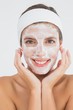 © WavebreakMediaMicro - Attractive woman having white cream on her face