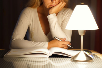 female student is reading book ..late at night