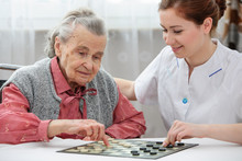 Senior Woman Playing Checkers