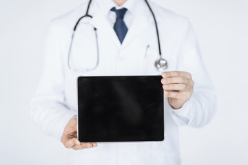 Wall Mural - male doctor holding tablet pc