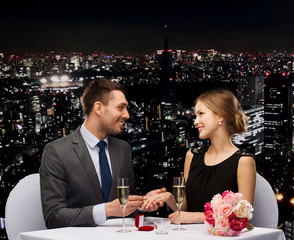 Poster - man proposing to his girlfriend at restaurant