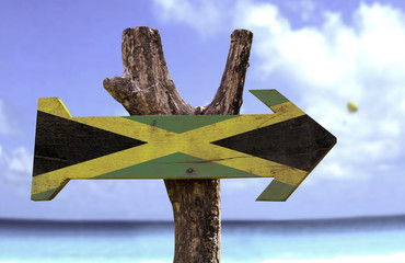 Wall Mural - Jamaica wooden sign with a beach on background