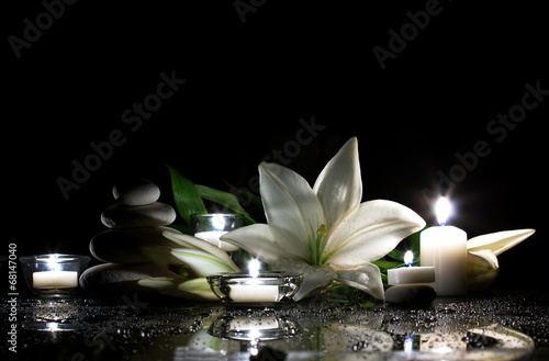 white lily, stones and candles © zaretskaya