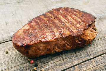 Delicious beef steak on wooden table