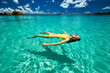 © haveseen - Woman in bikini lying on water