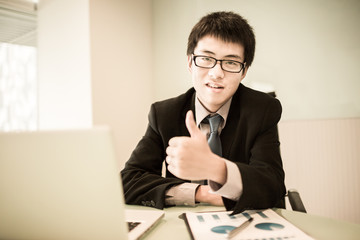 Wall Mural - Young handsome man using laptop in his office