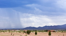 A Pair Of Lightning Strikes Above A Rural Neighborhood