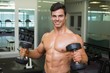 © WavebreakmediaMicro - Shirtless muscular man exercising with dumbbells