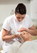 © danr13 - Cosmetician providing ultrasonic facial cleaning