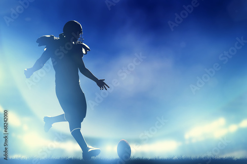 Fotografía American football player kicking the ball, kickoff