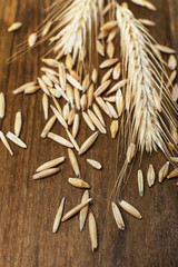 Wall Mural - Rye grains and ears on table, close-up