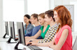 © Syda Productions - female student with classmates in computer class