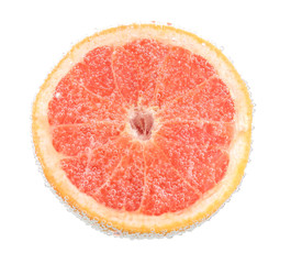 Wall Mural - Fresh grapefruit in water with bubbles , isolated on white